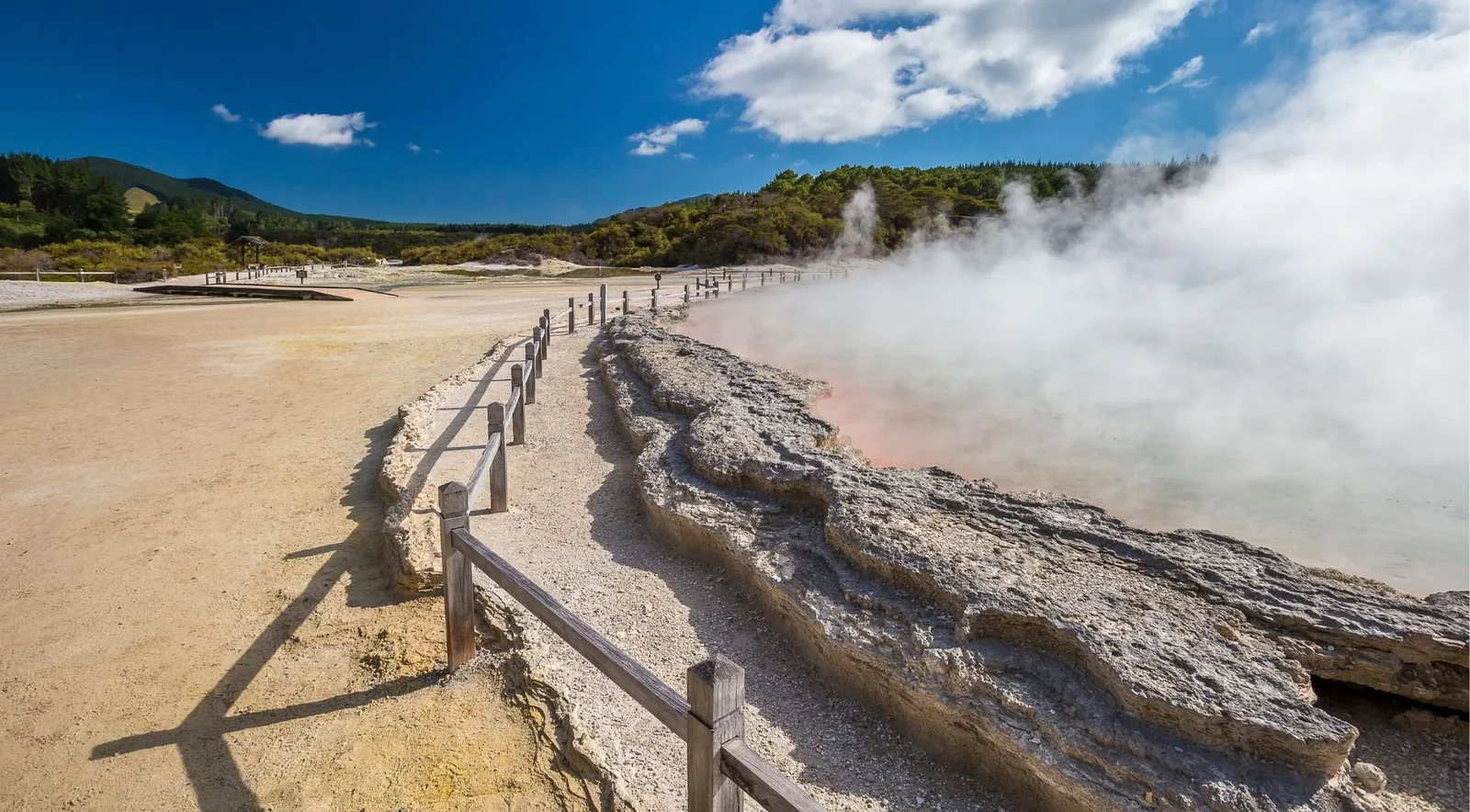 Rail fence along the pale sinter terrace beside the steaming Champagne Pool at Wai-O-Tapu