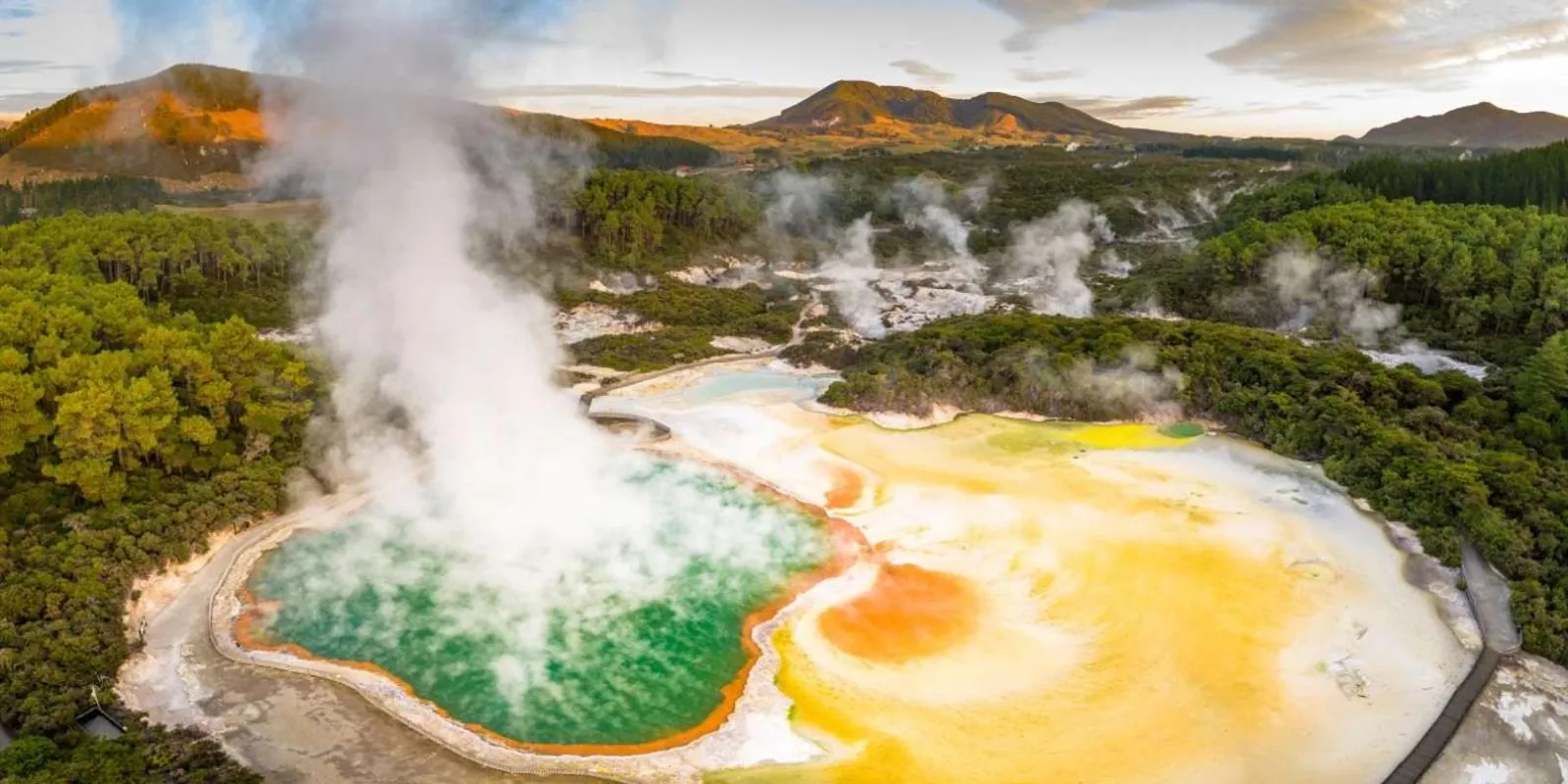 Golden-hour aerial of the Champagne Pool and Artist's Palette at Wai-O-Tapu