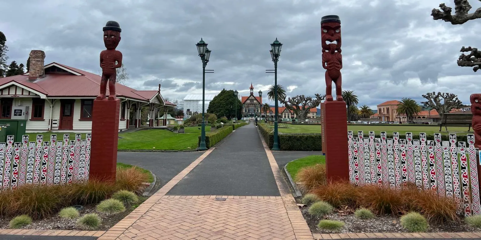 Carved pou and Rotorua Museum across the Government Gardens in central Rotorua